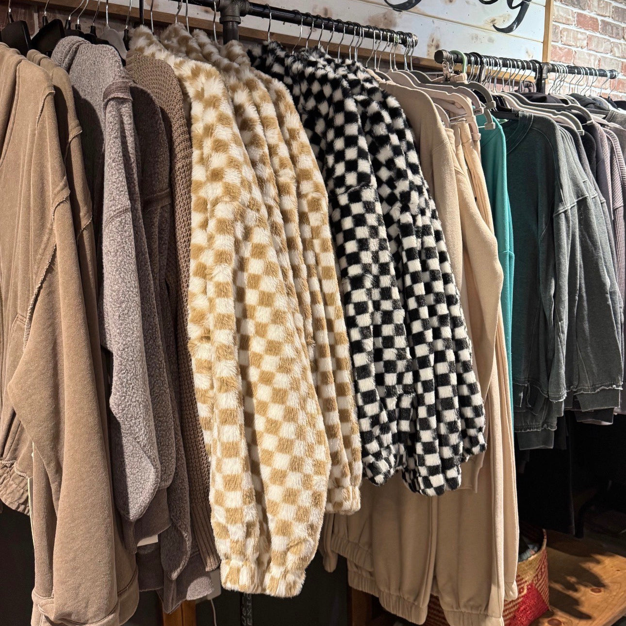 Clothing rack with various garments in a store named 'Lazydog'.